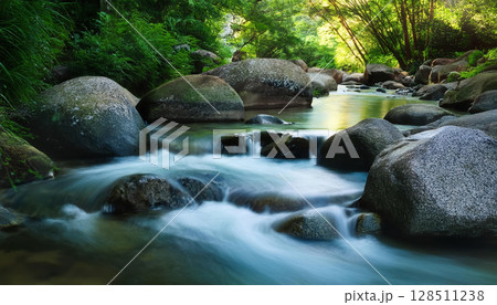 gently flowing stream surrounded by smooth stones and greenery evokes calm and recovery 128511238