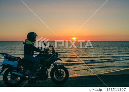 日本海に沈む夕陽とバイクとライダー 128511307