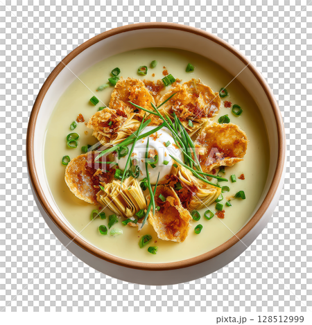 Artichoke soup with crispy chips, fresh chives, and creamy garnish served in bowl, presenting delicious and elegant dish 128512999
