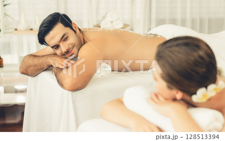 Blissful couple customer having exfoliation treatment in luxury spa. Quiescent Blissful couple customer having exfoliation treatment in luxury spa. Quiescent 128513394