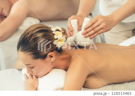 Hot herbal ball spa massage body treatment at day spa . Quiescent 128513465