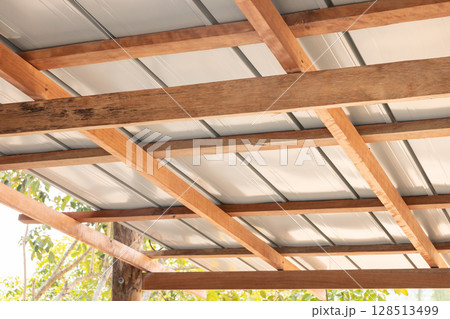 Roof under construction with metal sheet and wood structure. 128513499