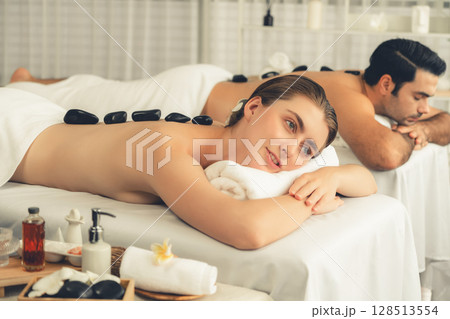 Hot stone massage at spa salon in luxury resort. Quiescent 128513554