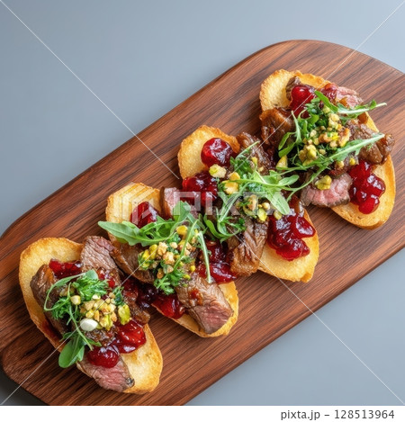 Elegant Venison Carpaccio on Crispy Crostini with Lingonberry Jam and Toppings for Gourmet Culinary Presentation 128513964