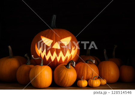 Halloween composition with glowing pumpkin face Halloween composition with glowing pumpkin face 128514546