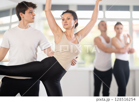 Young guy and adult woman rehearsing pair ballet Young guy and adult woman rehearsing pair ballet 128516254