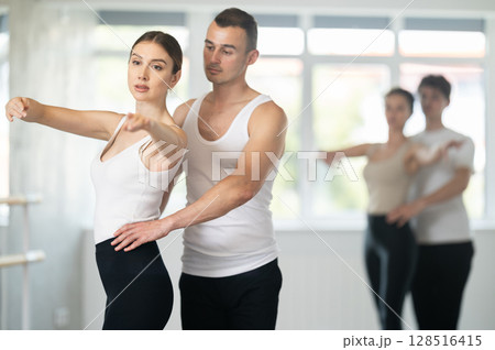 Young man and young woman rehearsing pair ballet Young man and young woman rehearsing pair ballet 128516415