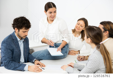 Male and female students learning course subject together Male and female students learning course subject together 128516761