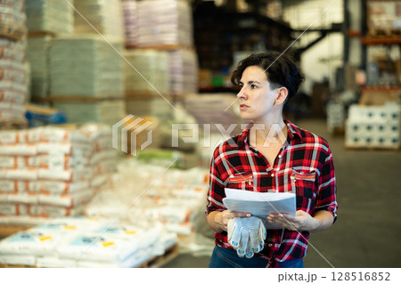 Woman making stock control in warehouse 128516852