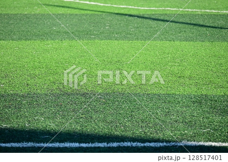 artificial green grass soccer field with sunlight, training football yard 128517401