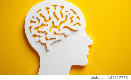 A yellow background features a white paper cutout of a human head, symbolizing mental health and emotional wellbeing awareness 128517778
