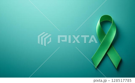 A green ribbon on a blue backdrop, signifying awareness and support for mental health and emotional wellbeing 128517785