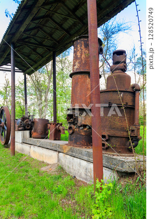 Old steaming threshing machine in Open air Museum of Folk Architecture and Folkways of Middle Naddnipryanschina in Pereyaslav, Ukraine 128520749