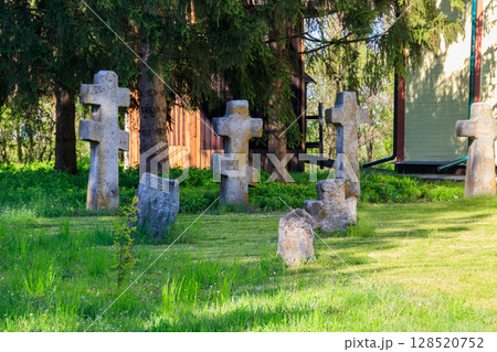 Old stone gravestones in the old abandoned cemetery 128520752