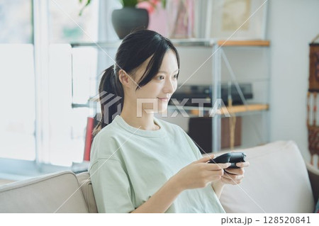 リビングでゲームをする女性 リビングでゲームをする女性 128520841