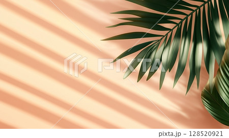 Green palm leaves of the edge frame decoration botanical nature copy space peach background 128520921