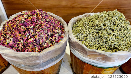 Fragrant dried herbs, spices and natural products in wooden barrels at a traditional Middle Eastern market Fragrant dried herbs, spices and natural products in wooden barrels at a traditional Middle Eastern market 128523090