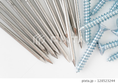 白背景に丸釘とタッピングねじのクローズアップ 128523244