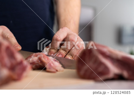 Chef Skillfully Prepares Meat in a Home Kitchen During a Morning Cooking Session Chef Skillfully Prepares Meat in a Home Kitchen During a Morning Cooking Session 128524085