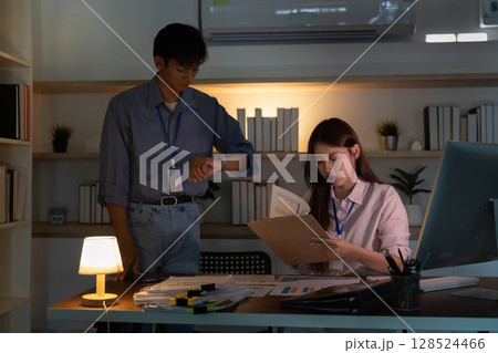 Team collaboration in a dimly lit office space Team collaboration in a dimly lit office space 128524466