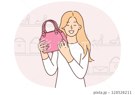 Happy woman chooses handbag standing in fashion store shopping in mall boutiques Happy woman chooses handbag standing in fashion store shopping in mall boutiques 128526211