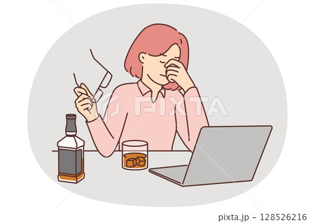 Businesswoman drinks whiskey sitting near laptop and feeling stressed after company goes bankrupt Businesswoman drinks whiskey sitting near laptop and feeling stressed after company goes bankrupt 128526216