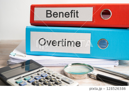 Overtime, Salary. Binder data finance report business with graph analysis in office. Overtime, Salary. Binder data finance report business with graph analysis in office. 128526386