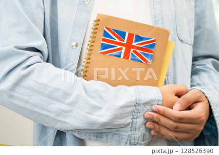 Learn English language, Asian teenage student hold book with flag in course at school. 128526390