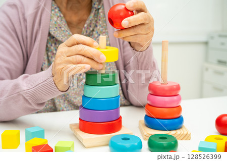 Asian elderly woman patient suffering from dementia learn practical motor skills rehabilitation. Asian elderly woman patient suffering from dementia learn practical motor skills rehabilitation. 128526399