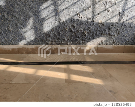 Fungal Wall Decay under Sunlight with Deep Shadows on White Marble Tiles Fungal Wall Decay under Sunlight with Deep Shadows on White Marble Tiles 128526495