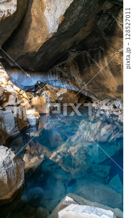 Grjotagja cave in Iceland, a hidden volcanic hotspot with crystal-clear geothermal waters near Lake Myvatn, once featured in Game of Thrones. Grjotagja cave in Iceland, a hidden volcanic hotspot with crystal-clear geothermal waters near Lake Myvatn, once featured in Game of Thrones. 128527011