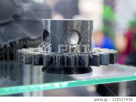Object printed on 3D printer. Model created on 3D printer from black molten plastic. Creative shape printed on 3D printer. Additive progressive high-tech technology. 3D printing technology Object printed on 3D printer. Model created on 3D printer from black molten plastic. Creative shape printed on 3D printer. Additive progressive high-tech technology. 3D printing technology 128527438