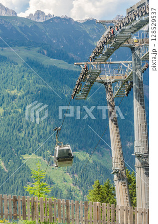 Modern Cable Car Ascends Alpine Mountains on a Sunny Summer Day. High quality photo Modern Cable Car Ascends Alpine Mountains on a Sunny Summer Day. High quality photo 128529537