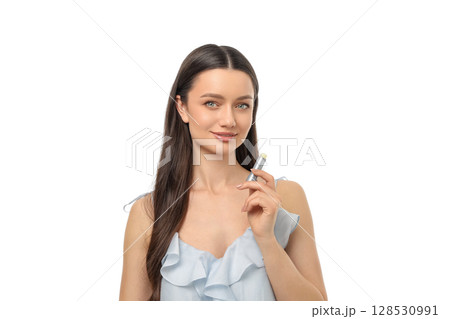 Woman with long hair holds skincare item, smiling, isolated on white, PNG 128530991