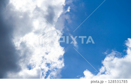 Summer sky. Cumulus clouds on a blue background. Partly cloudy. Summer sky. Cumulus clouds on a blue background. Partly cloudy. 128531785