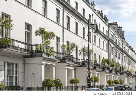 Elegant Georgian terrace houses with iron balconies and potted plants in London Elegant Georgian terrace houses with iron balconies and potted plants in London 128533521