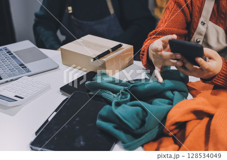 Portrait of Starting small businesses SME owners, two Asian woman check online orders Selling products working with boxs freelance work at home office, sme business online small medium enterprise 128534049