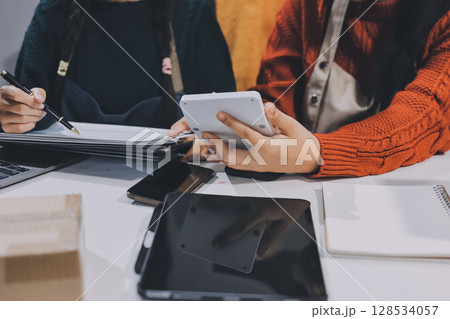 Portrait of Starting small businesses SME owners, two Asian woman check online orders Selling products working with boxs freelance work at home office, sme business online small medium enterprise 128534057