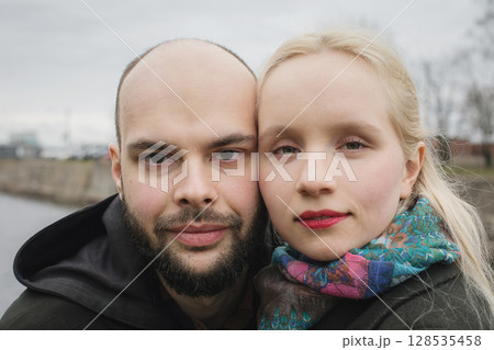 Close-up face of young woman with blond hair and handsome man outdoors. Happy couple 128535458