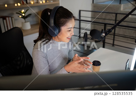 Podcast host recording engaging content with enthusiasm 128535535