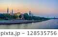 Panoramic view of Riga old town, Latvia at dusk with the Daugava River, Riga Castle, historic church spires, and city skyline under a soft pastel sky. 128535756