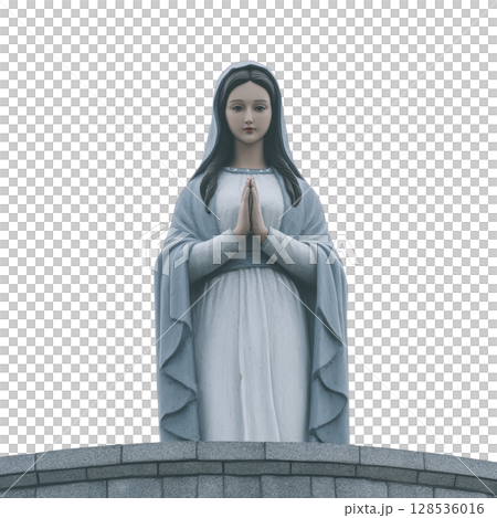 Serene statue of woman in blue and white robe stands with hands in prayer, symbolizing peace and devotion. figure is positioned on stone pedestal, evoking sense of reverence 128536016