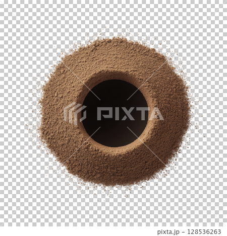 Circular mound of brown powder is surrounded by scattered dusting, creating textured and dynamic visual. central void adds depth and contrast to composition 128536263