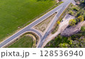 Empty Road Surrounded by Green Fields and Nature 128536940