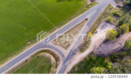 Empty Road Surrounded by Green Fields and Nature Empty Road Surrounded by Green Fields and Nature 128536940