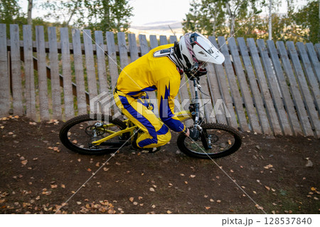 extreme mountain biker riding downhill on turn trail during race competition extreme mountain biker riding downhill on turn trail during race competition 128537840