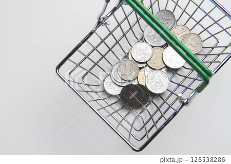 Food price. Money and a grocery basket. Payment in the store. 128538286