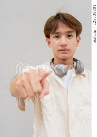 Non binary cute Asian young gay man pointing finger at you Non binary cute Asian young gay man pointing finger at you 128539801