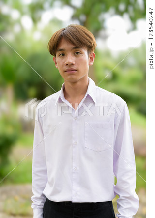 Non binary university student in college campus 128540247