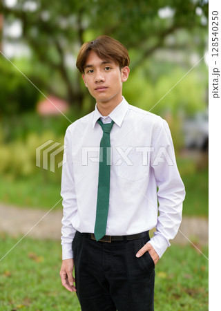 Non binary university student in college campus Non binary university student in college campus 128540250
